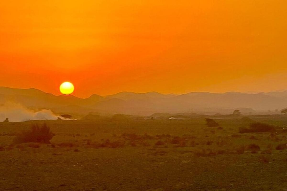 Una puesta de sol en el desierto con la puesta del sol