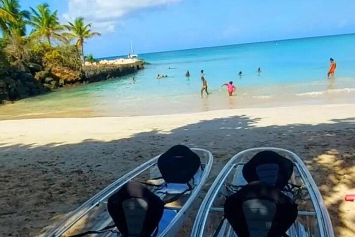 a boat on a beach with people in the water