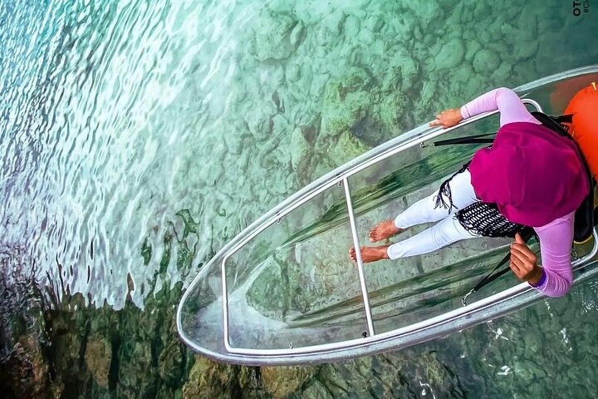 a person on a glass object in the water