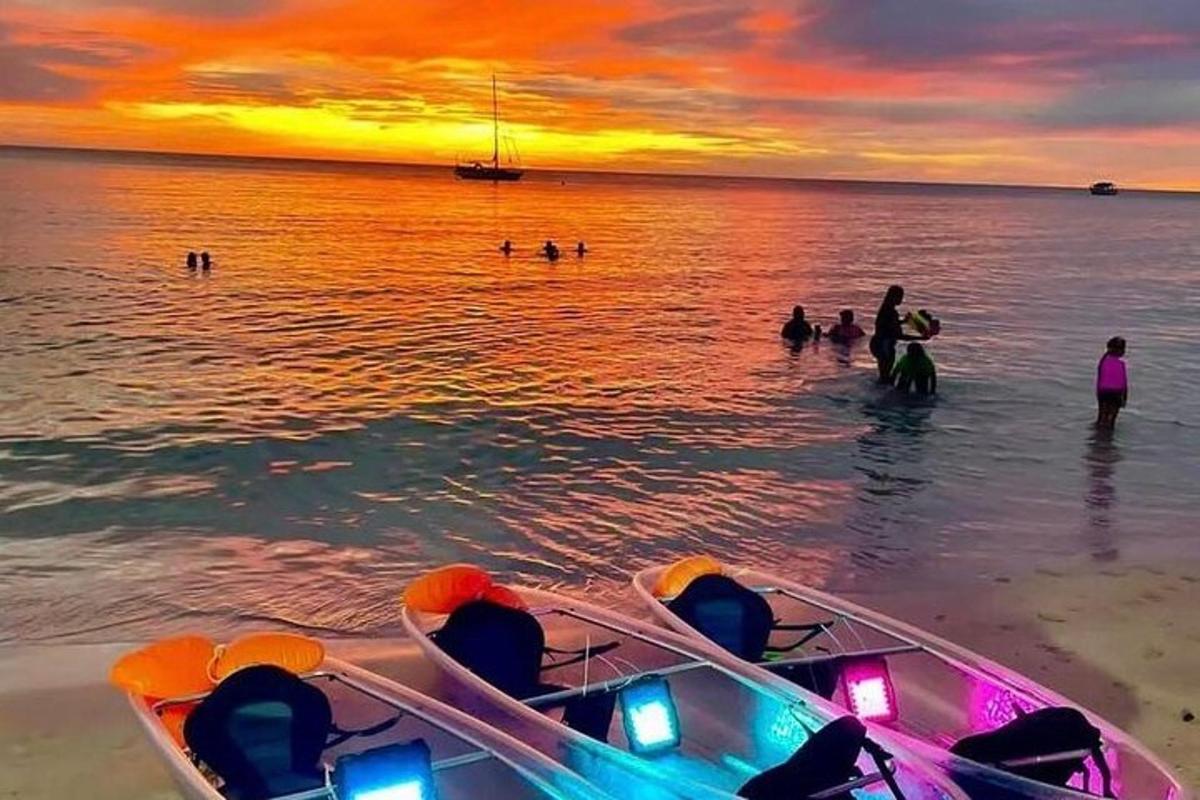 a group of people in the water at the beach