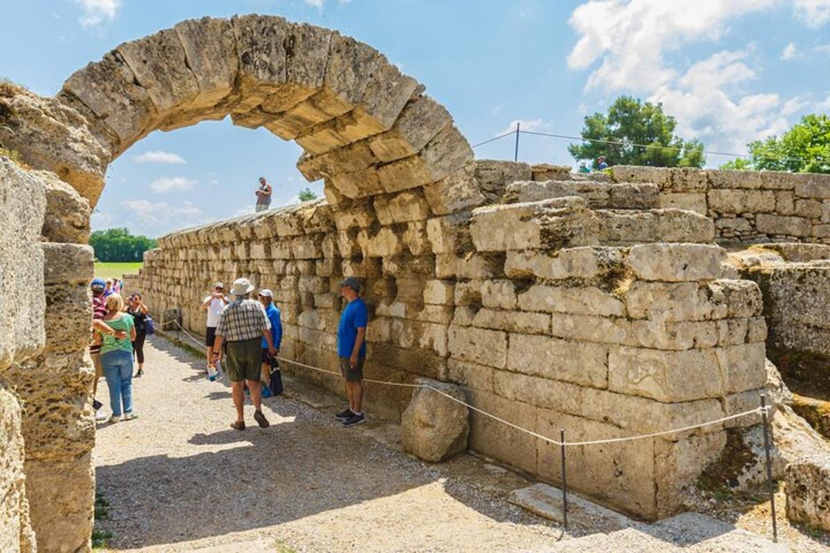 a group of people standing around a stone wall