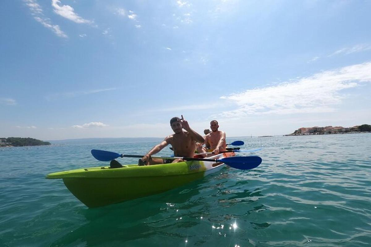 two men in a yellow kayak in the water