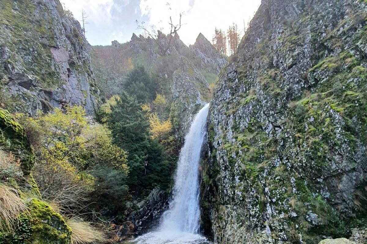 a waterfall on the side of a rocky mountain
