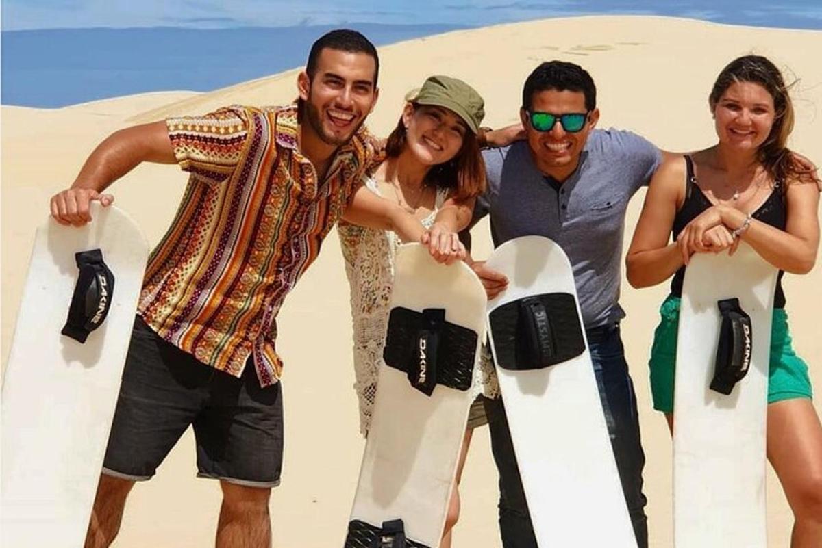 a group of people posing for a picture with snowboards