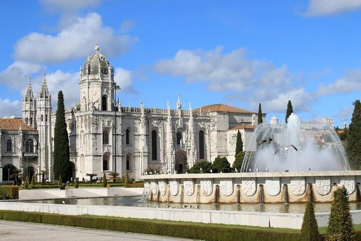 a large white building with a fountain in front of it