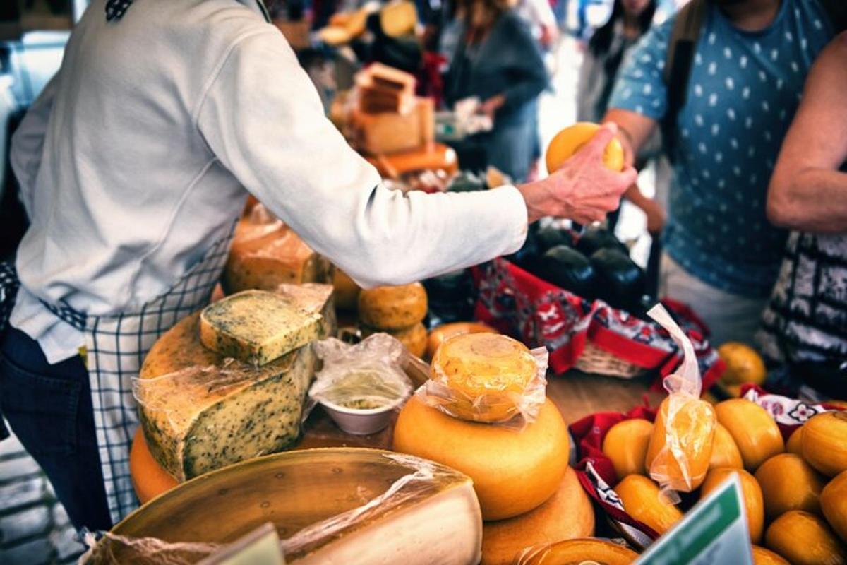 a person holding a piece of fruit at a market