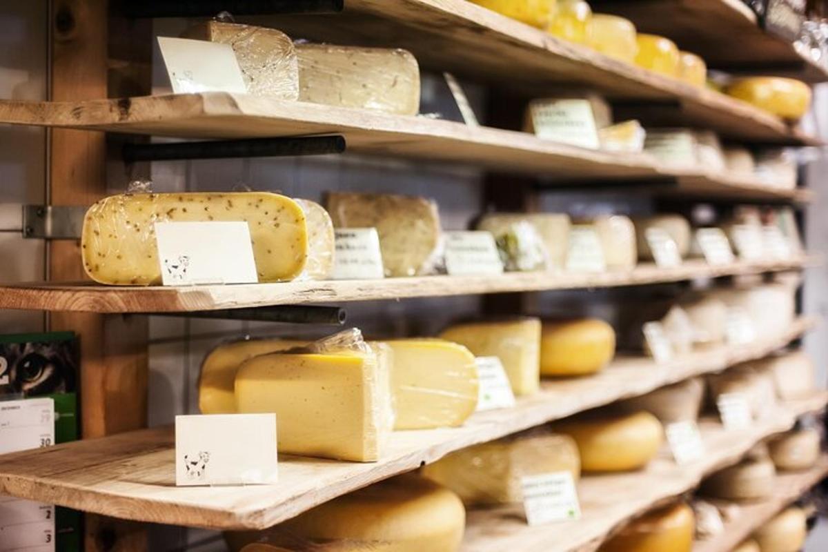 a display of cheese on shelves in a store