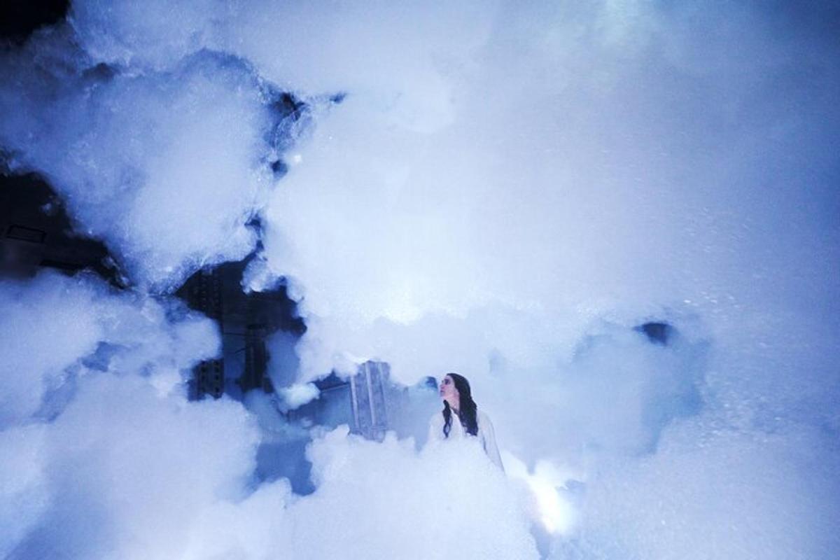 a woman is standing in a cloud of smoke