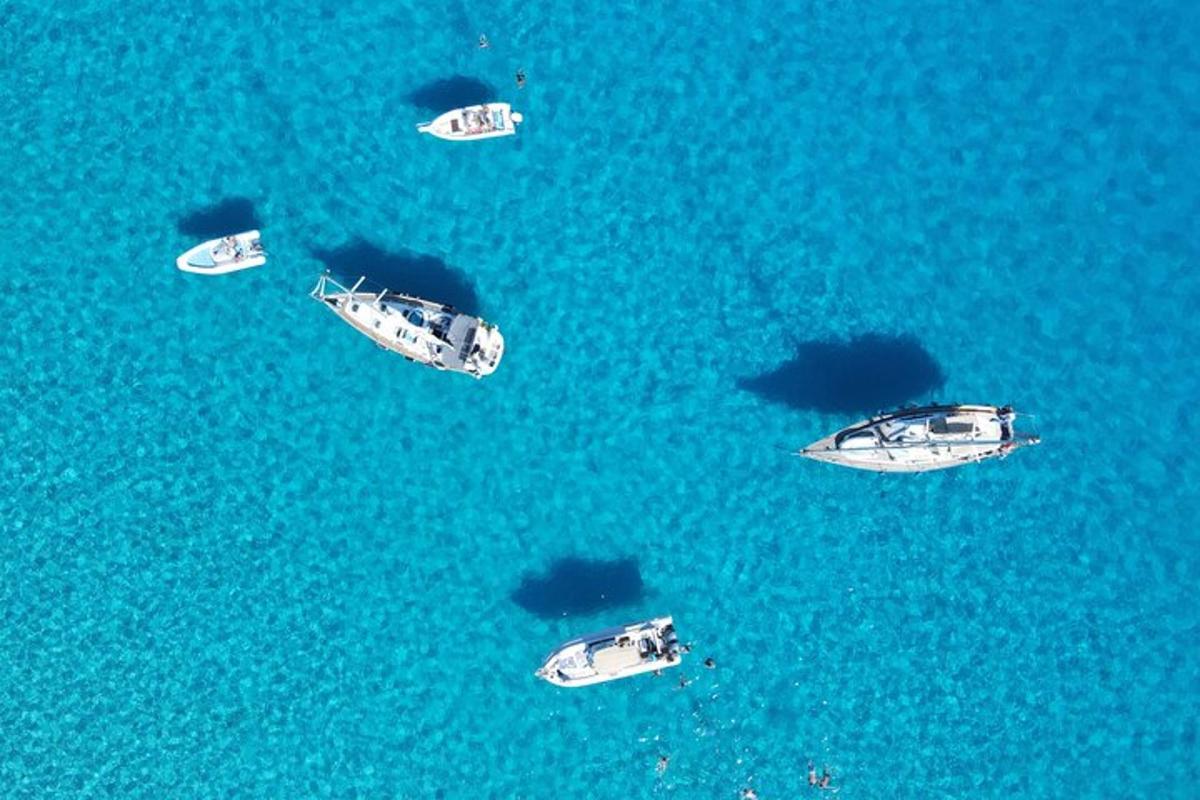 a group of boats in the blue water