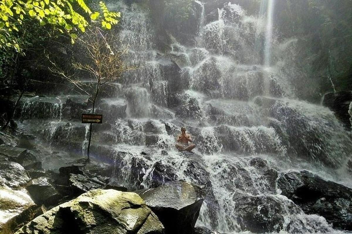 a person sitting on top of a waterfall