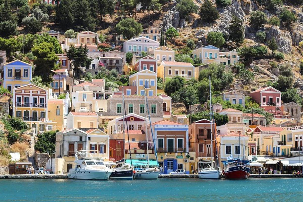 a group of houses on a hill with boats in the water