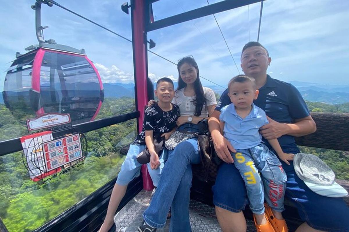 a family sitting on a gondola ride in the sky
