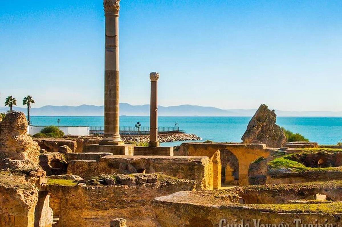 an ancient ruins with the ocean in the background