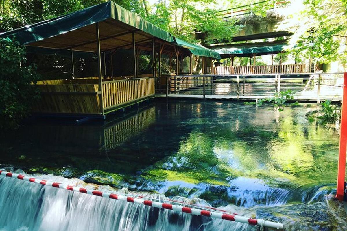 a swimming pool with a waterfall and a building