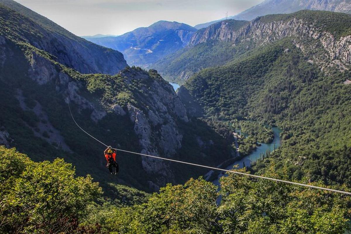 dağlarda zipline'da bir kişi