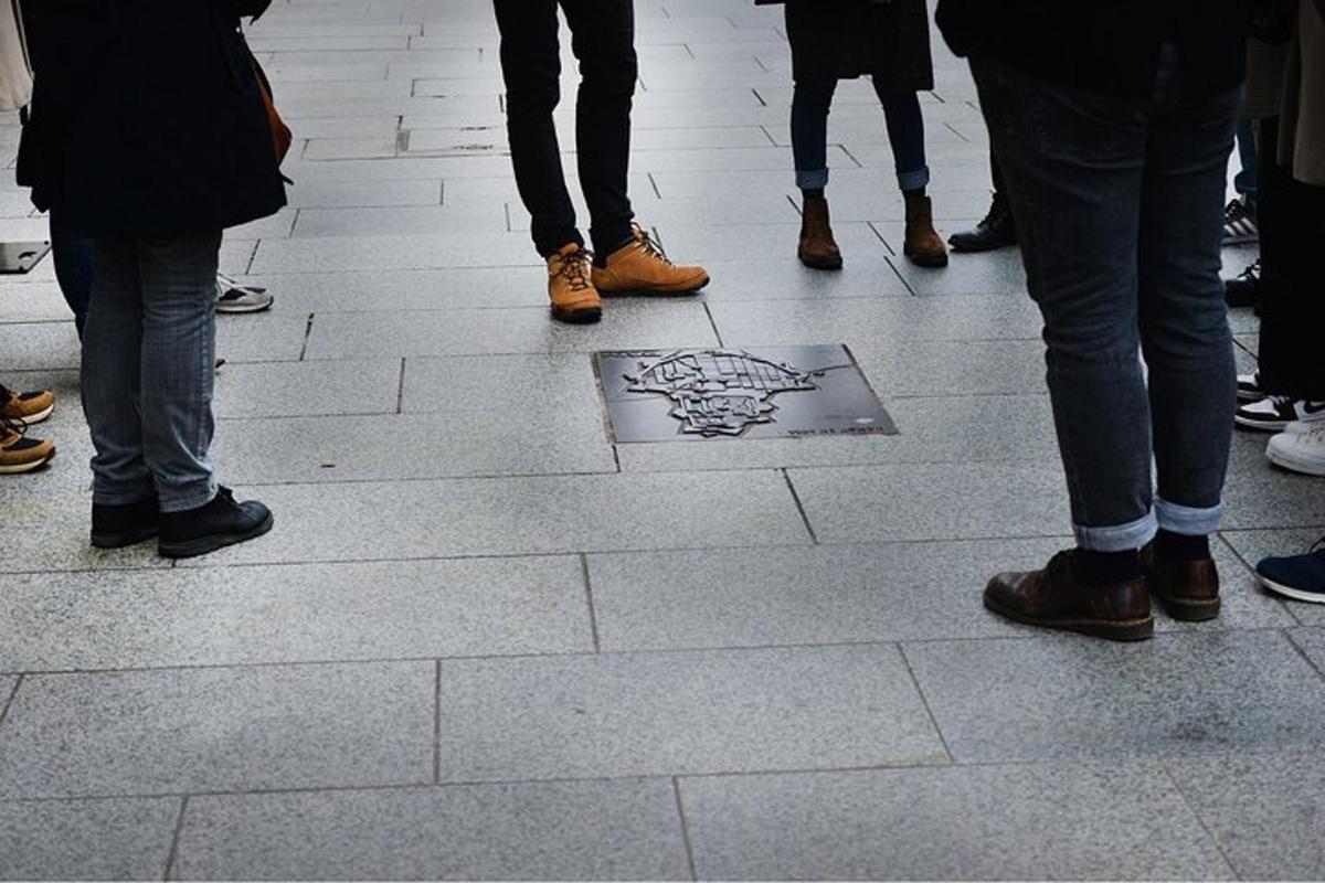 a group of people standing around a drawing on the ground