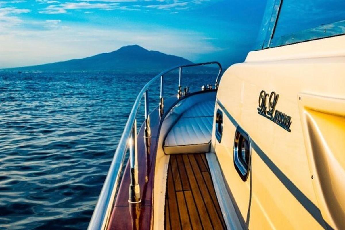 a boat on the water with a mountain in the background