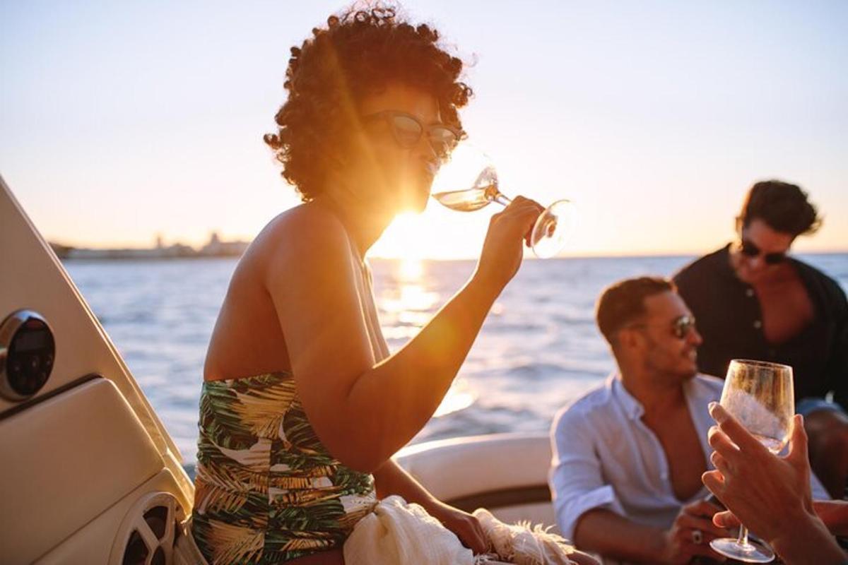 a woman drinking a glass of wine on a boat