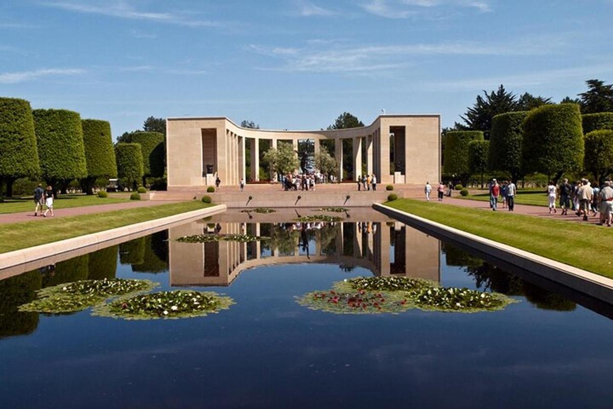 a large building with a pond in front of it