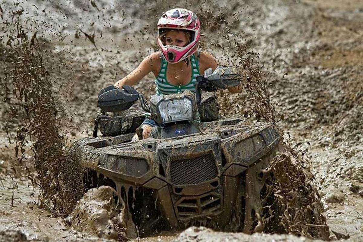 isang batang nakasakay sa quad bike sa putikan