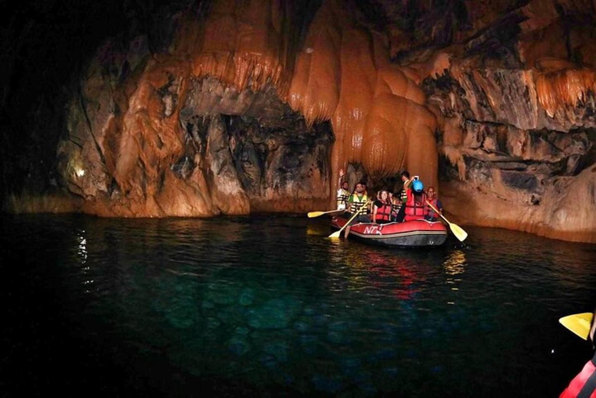 a group of people in a boat in a cave