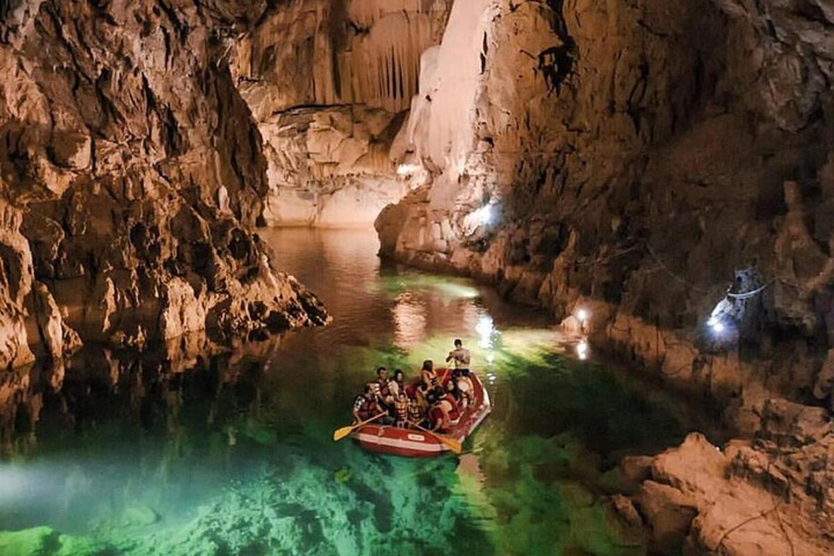 a group of people in a boat in a cave