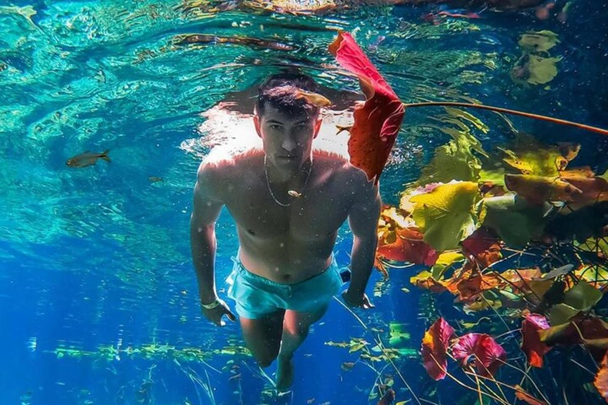a young man in the water with a plastic bag
