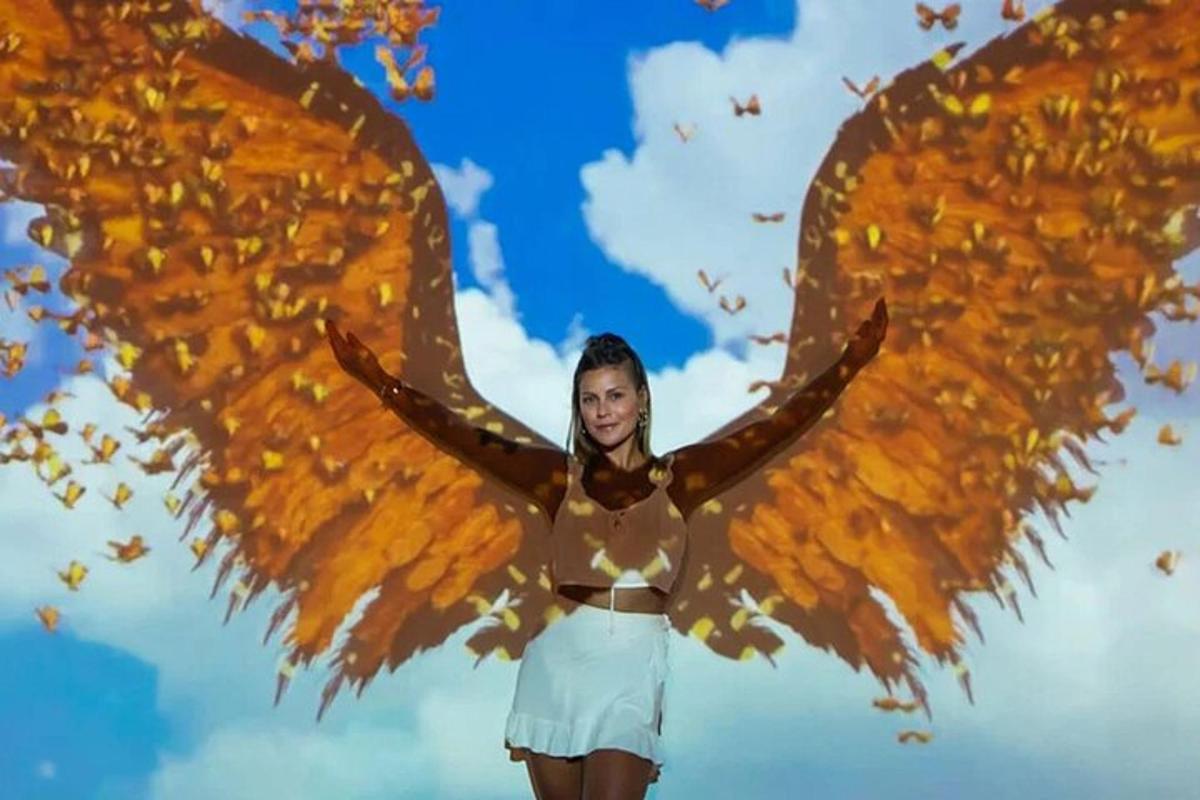 a woman with a large wings painted on her back