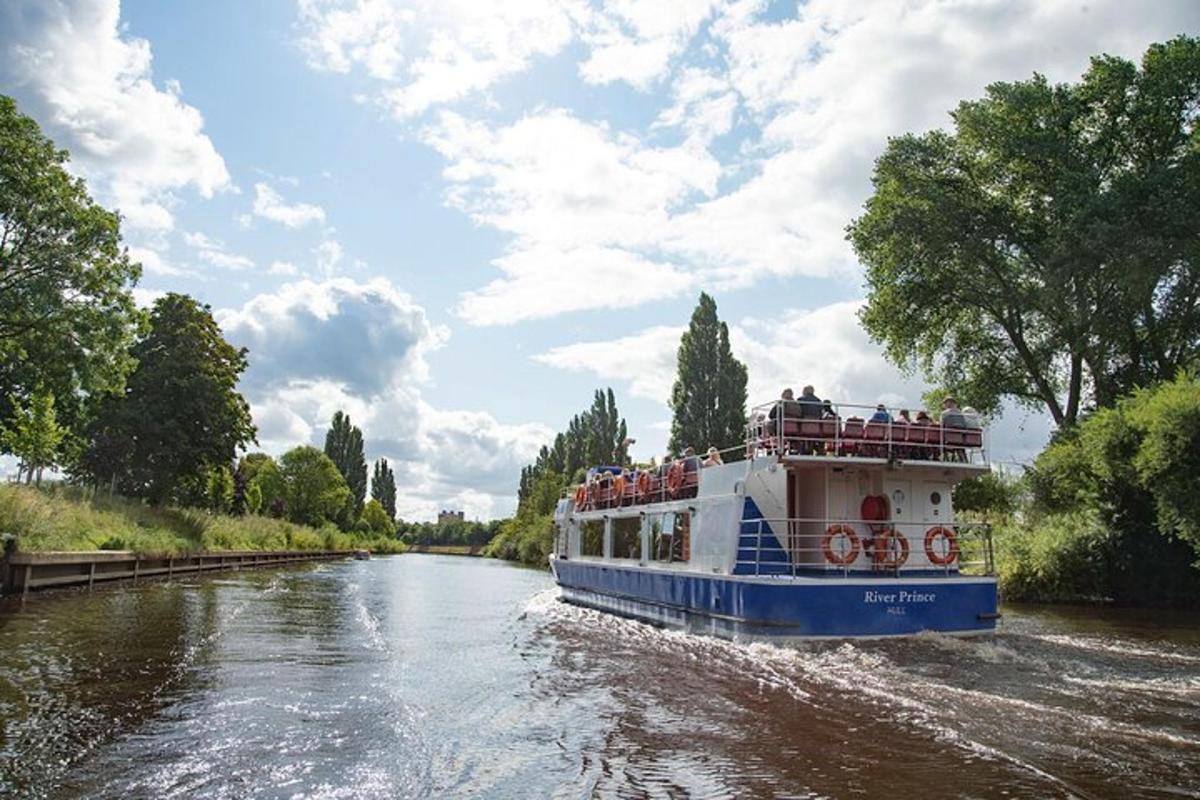 a boat traveling down a river with people on it