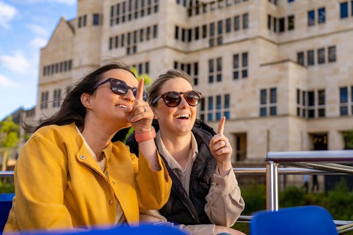 two women sitting next to each other in front of a building