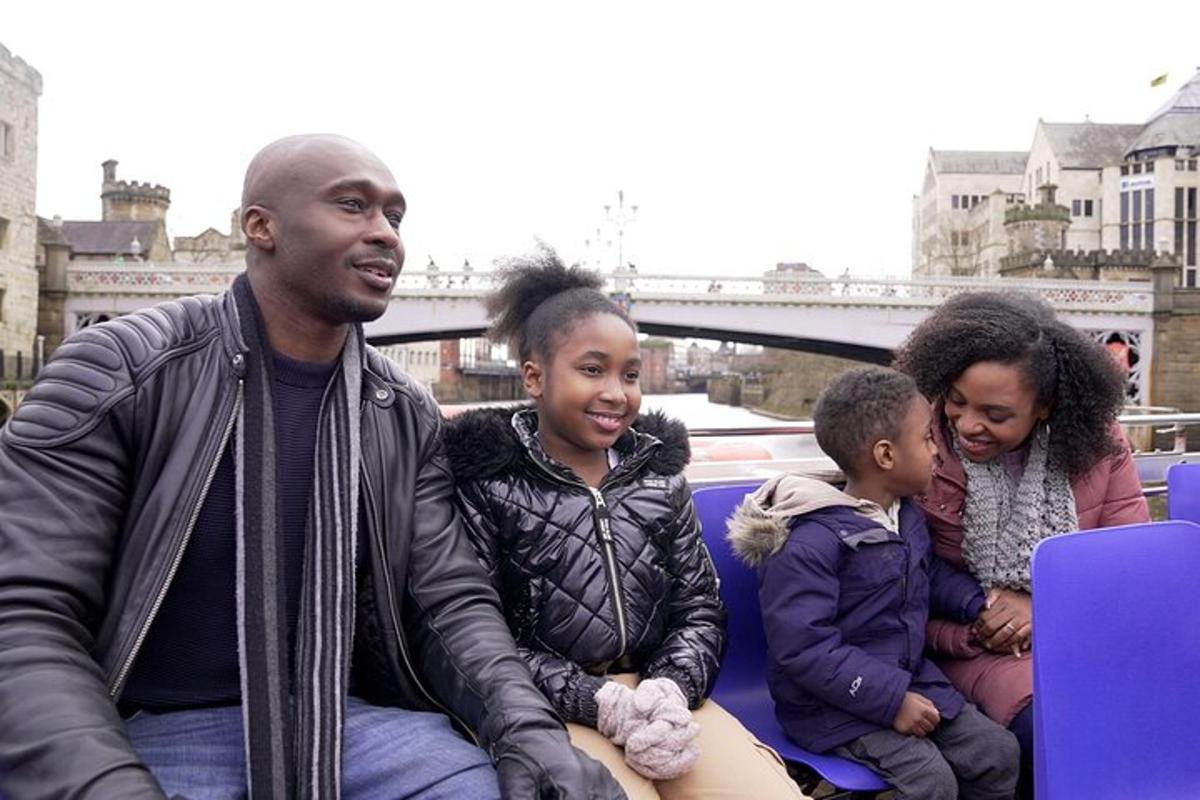a man and three children sitting on a boat