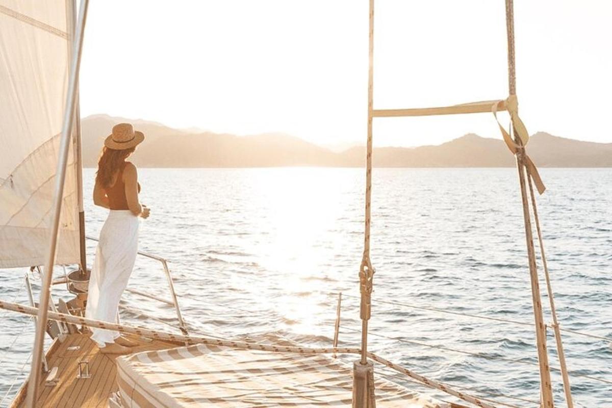 a woman standing on a sail boat in the water