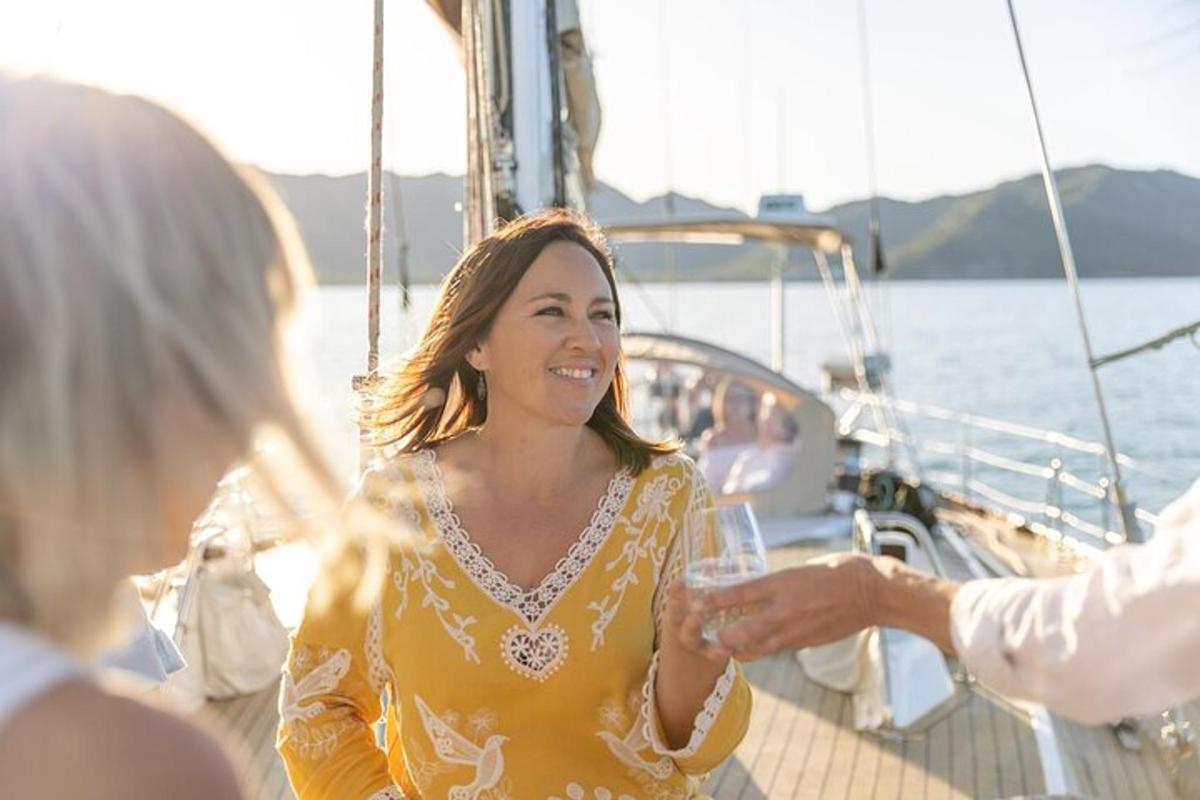 a woman holding a glass of wine on a boat