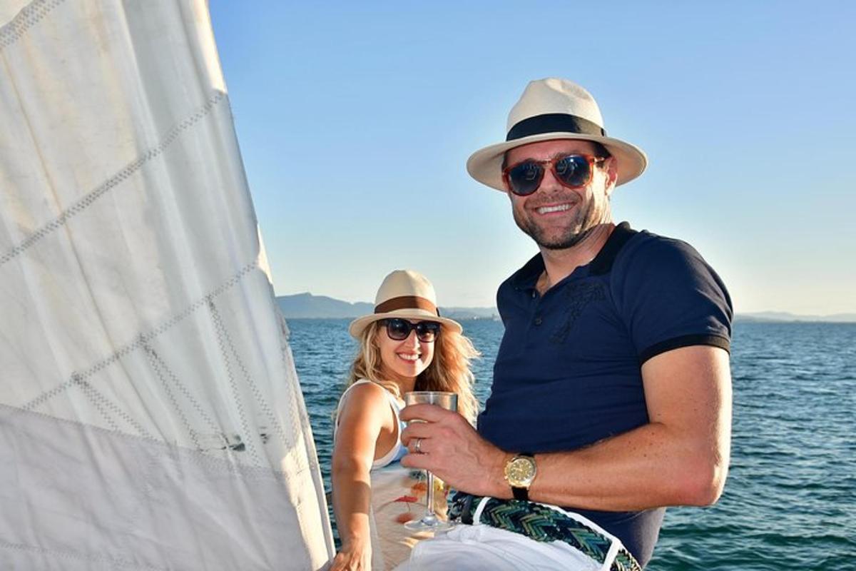 a man and woman standing on a sail boat