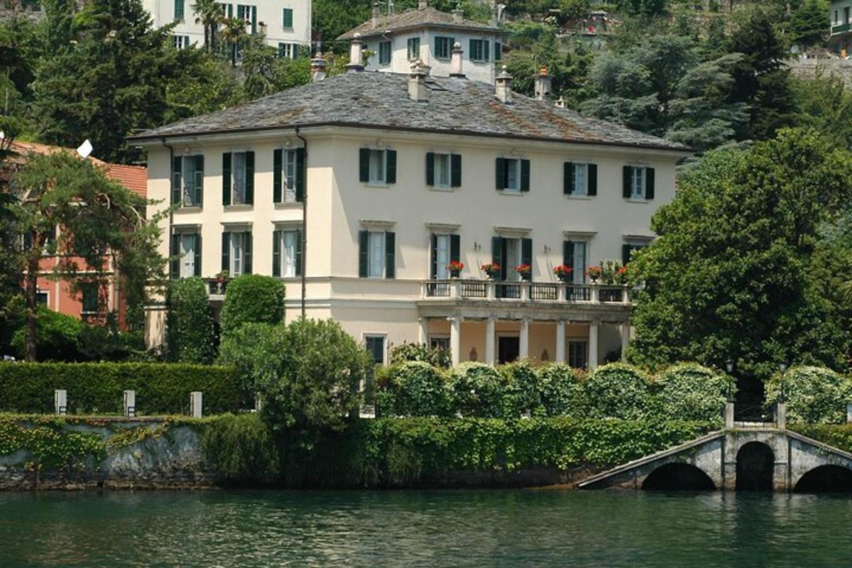 a large white house with a bridge over a body of water