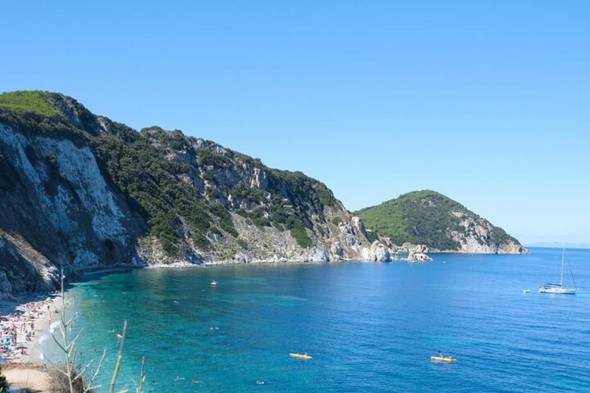 a beach with people and boats in the water