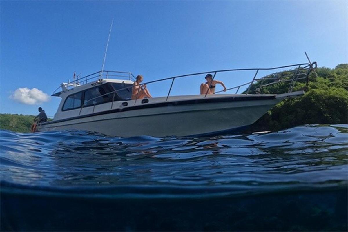 a group of people on a boat in the water