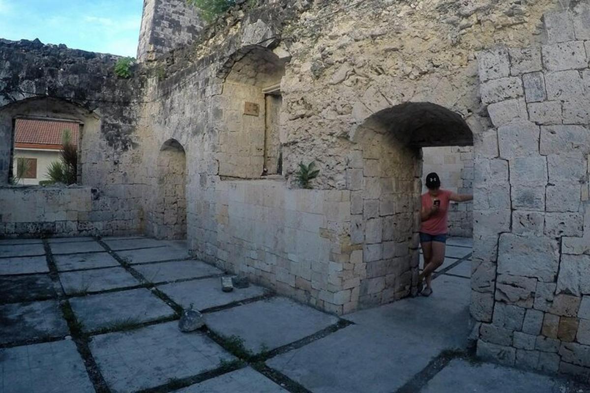 una persona dreta en un carreró d'un edifici de pedra