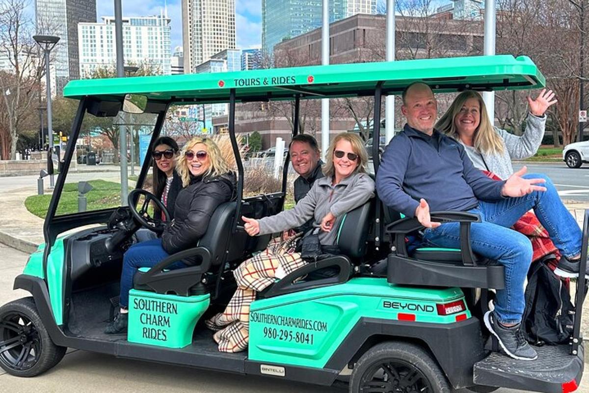 a group of people sitting in a golf cart