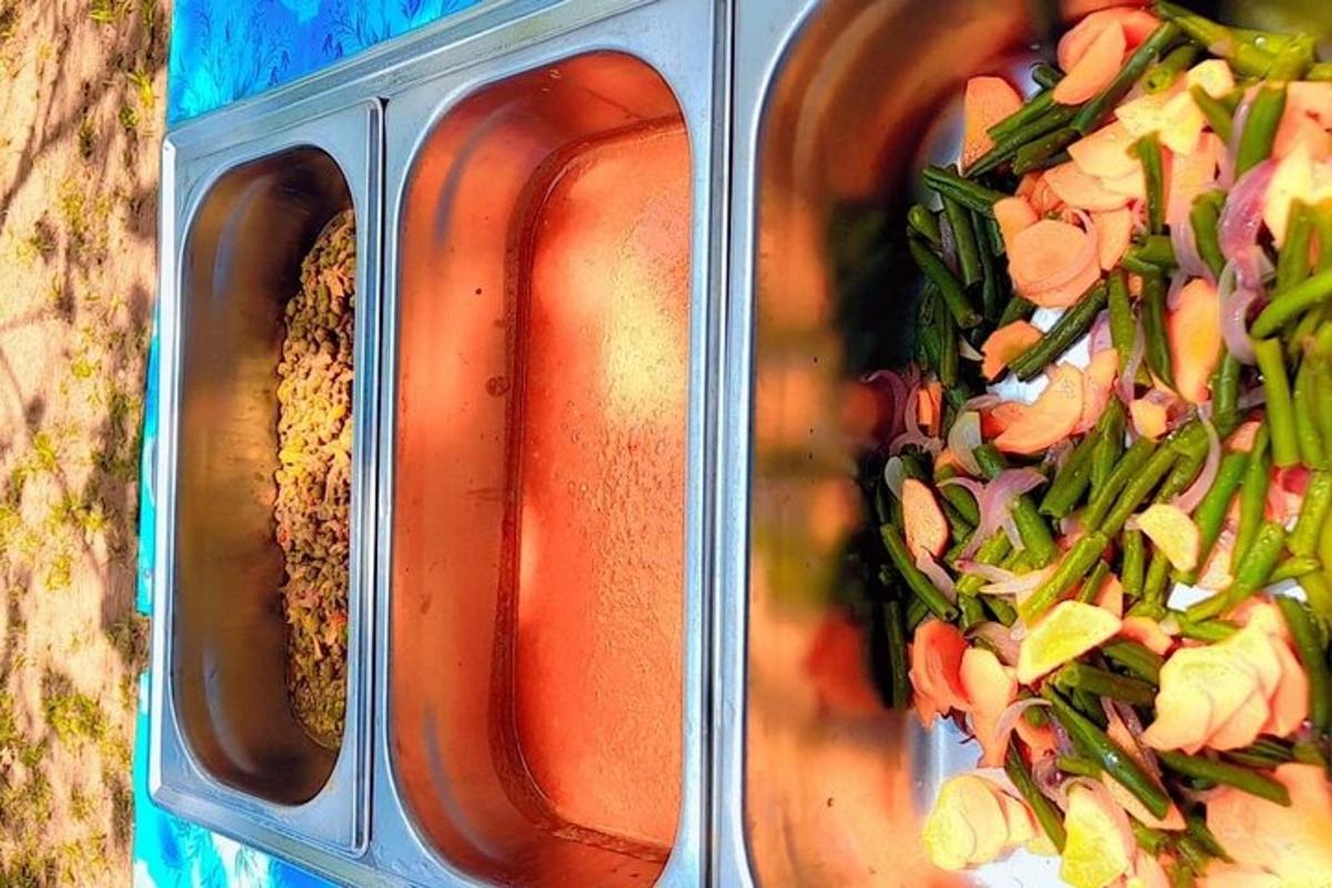 two containers of food with vegetables and sauce