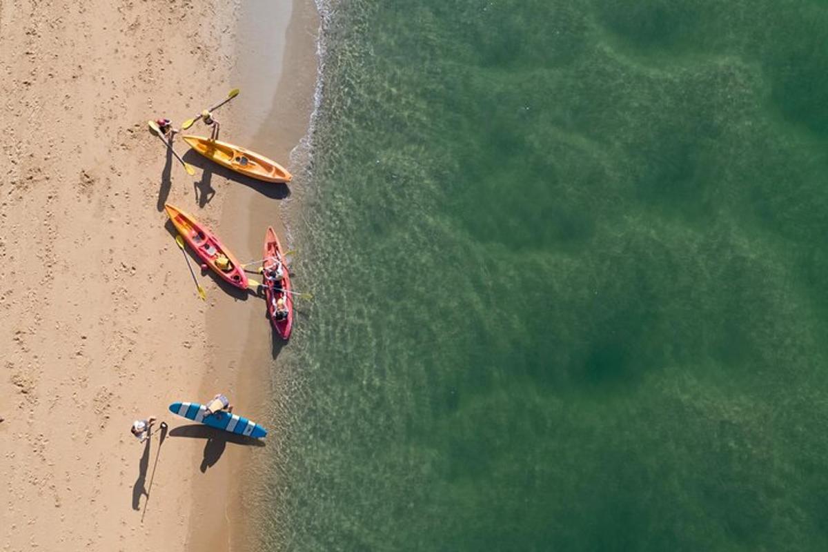 an overhead view of two boats on the beach