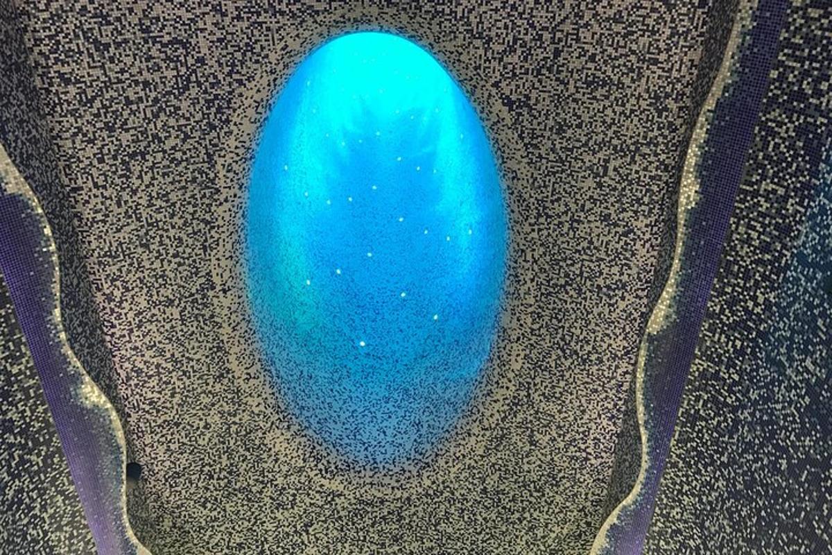 a blue egg is sitting on the ground