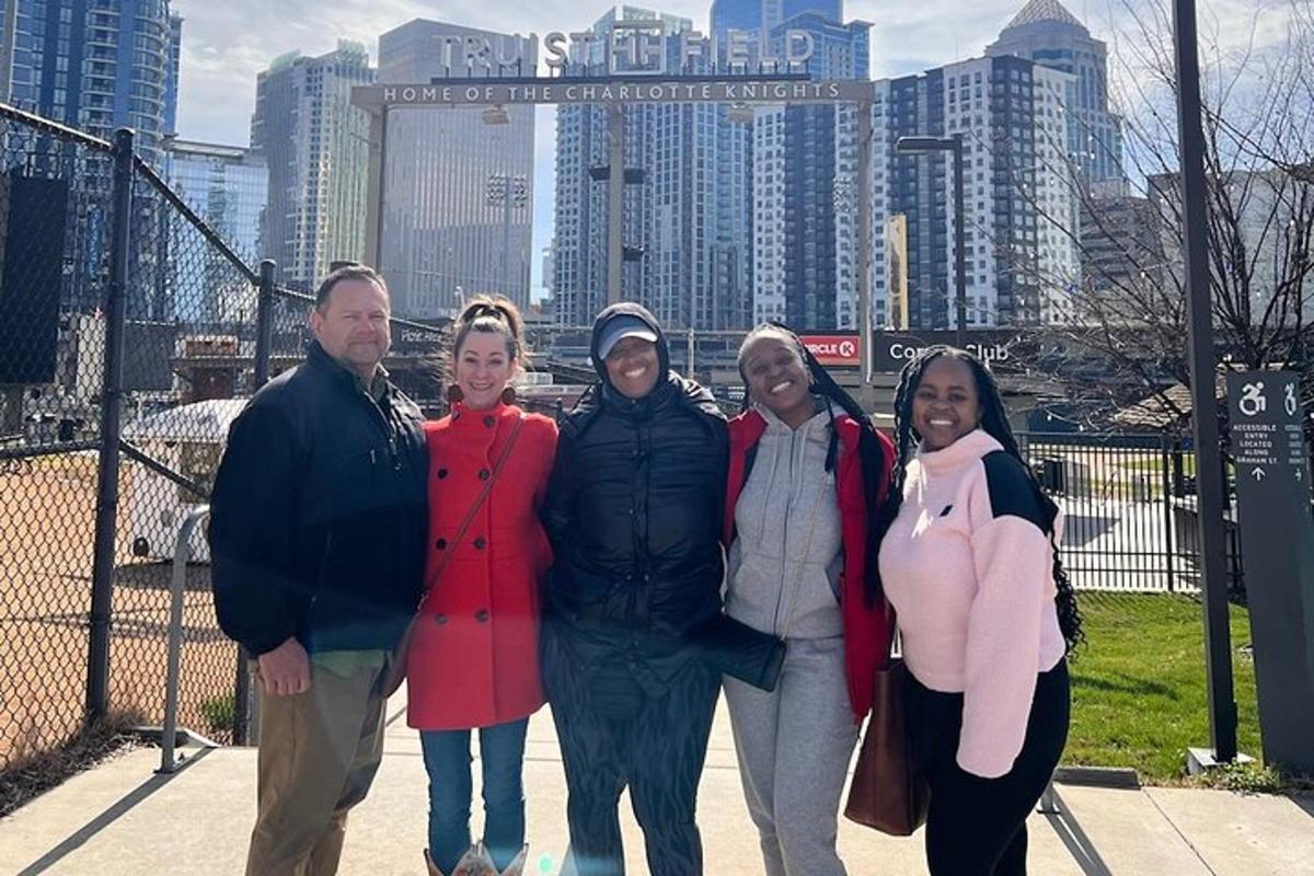 a group of people posing for a picture in front of a city