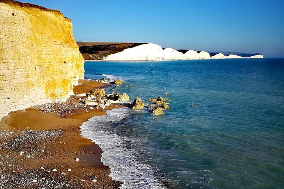 a rocky beach with icebergs in the ocean
