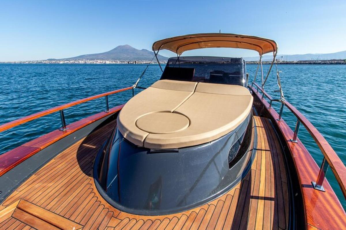um barco de madeira na água com montanhas ao fundo