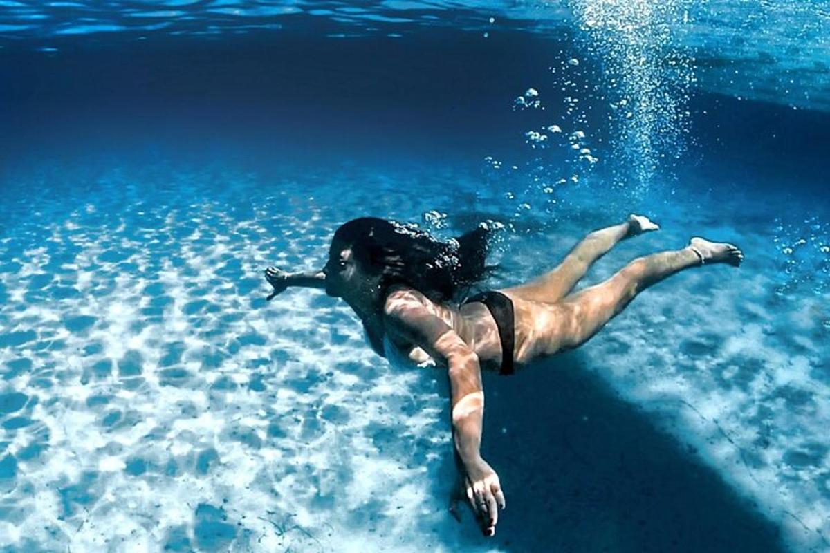 a woman laying in the water in the ocean