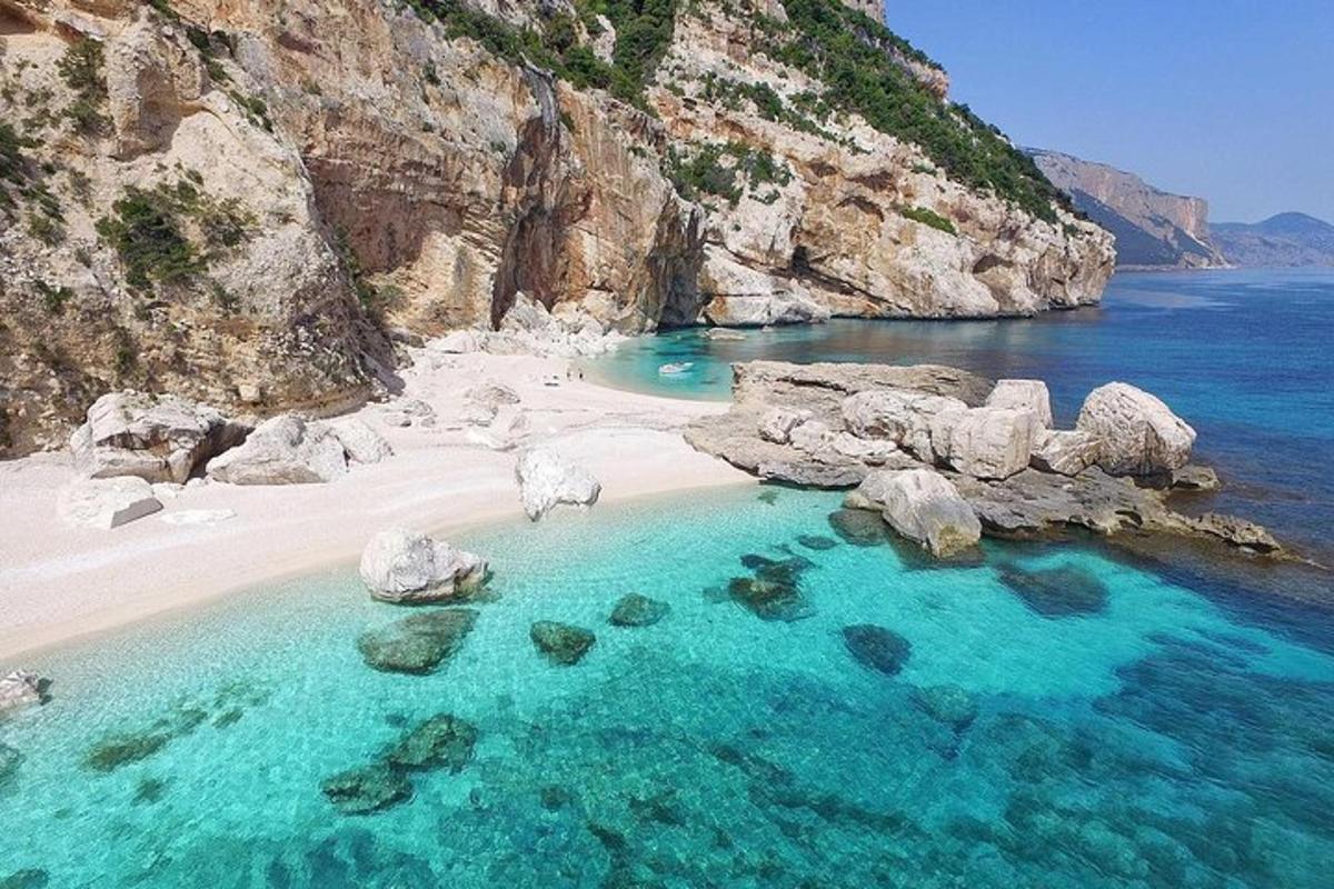 an aerial view of a beach with rocks and water