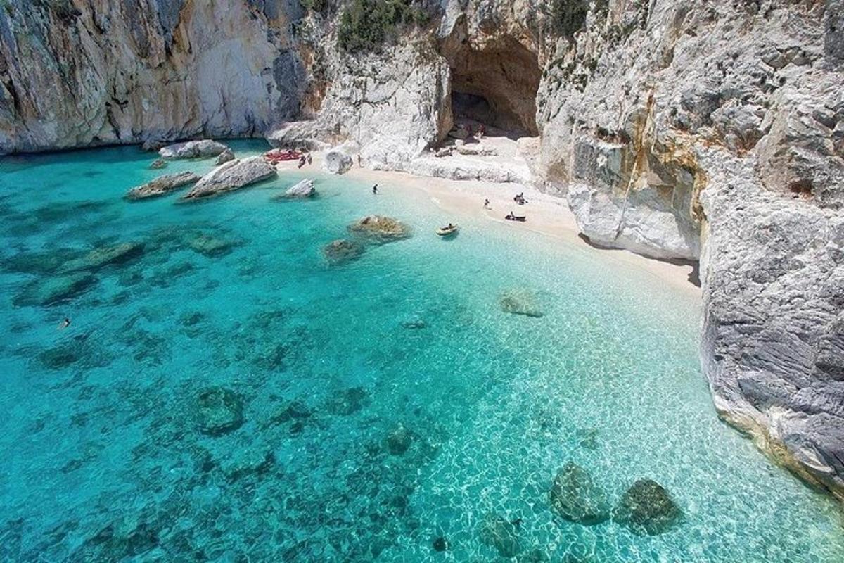 an aerial view of a beach with people in the water