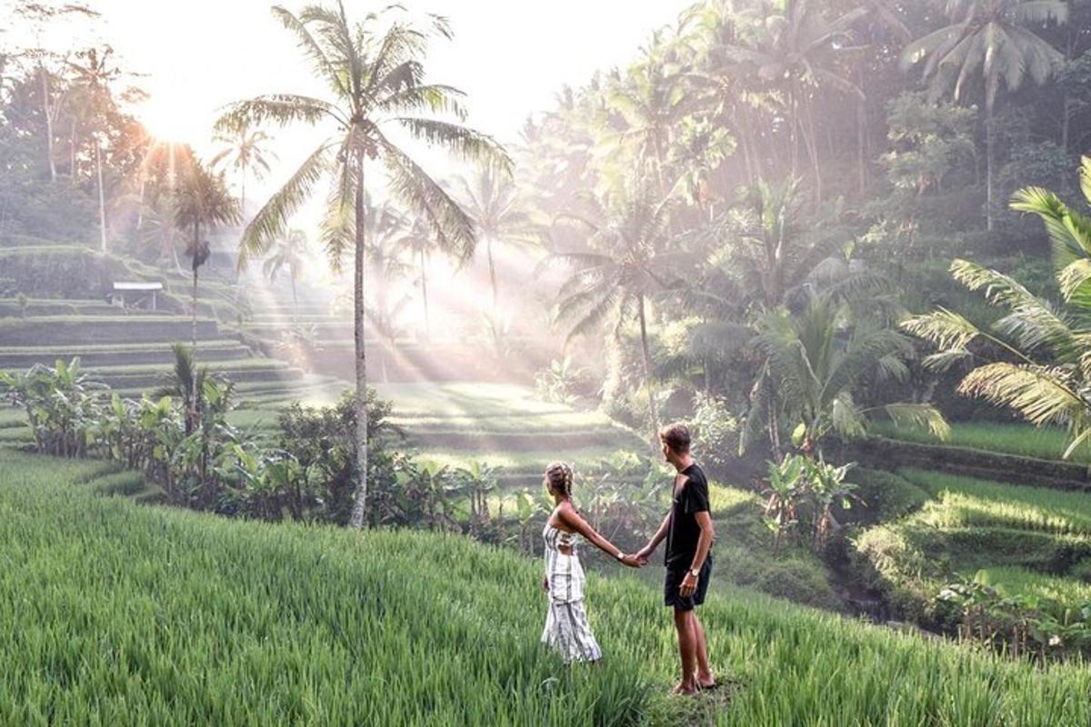 a man and a child standing in a field holding hands