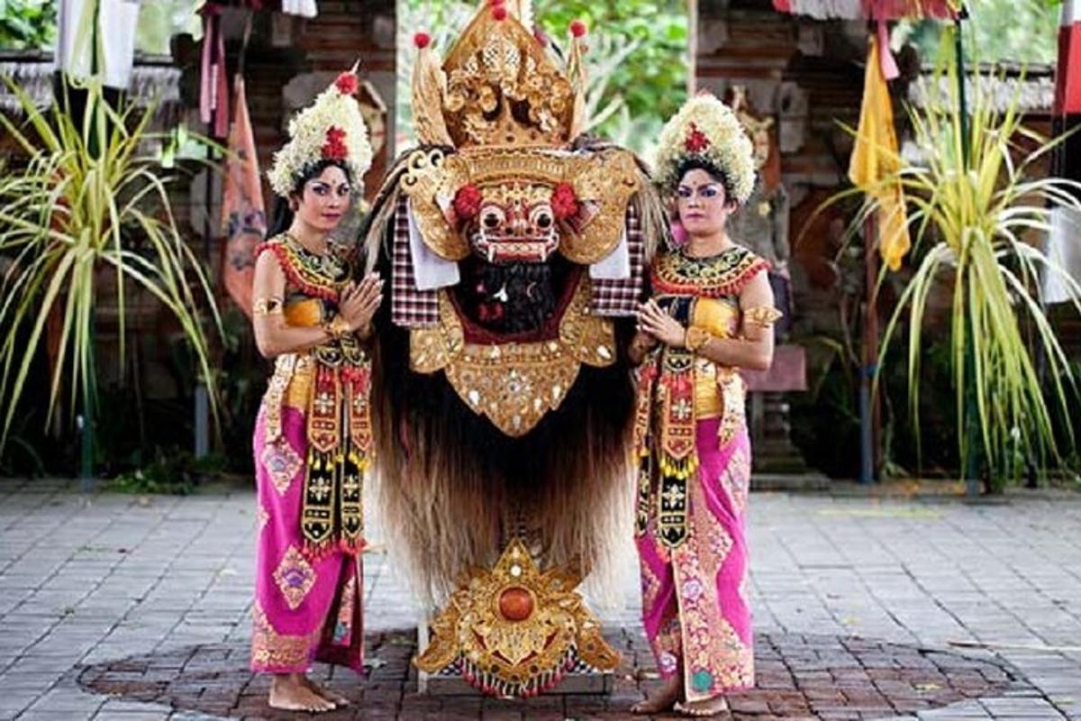 two women are standing in front of a lion mask
